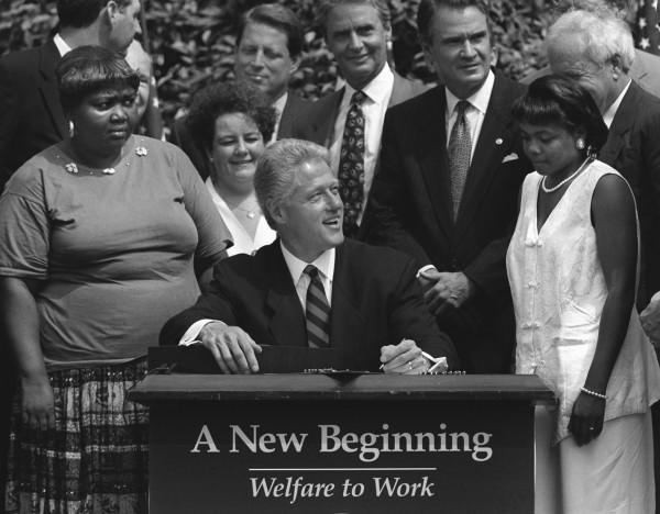 Bill Clinton signs the 1996 Welfare Reform Act. (AP Photo/J. Scott Applewhite via JacobinMag)