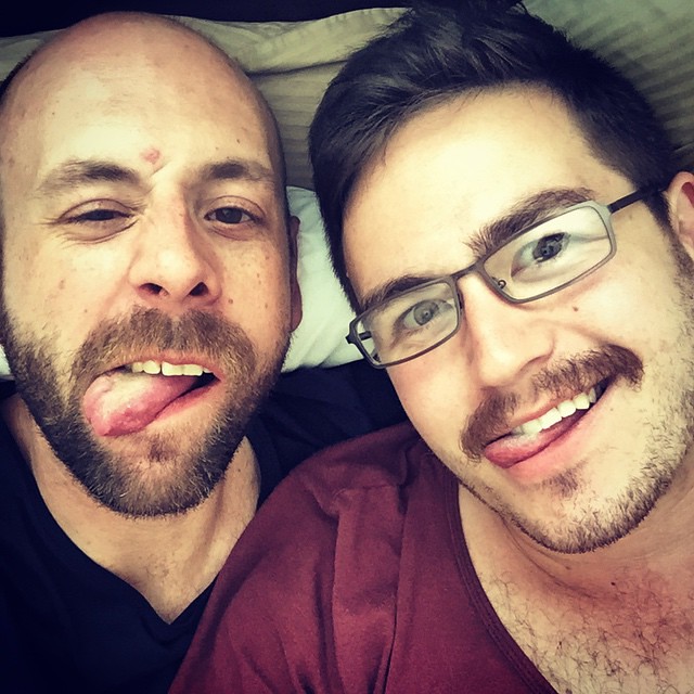 Photo of two men sticking their tongue out for a selfie