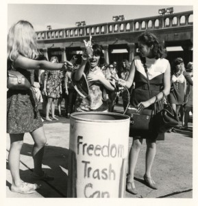 Feminist dumping bras and make-up into freedom trash can at 1968 Miss America Pageant