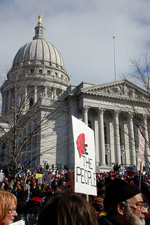 A sign at the Madison, WI protests demonstrates the common language of 2011's uprisings. Photo by OnTask via flickr.com.
