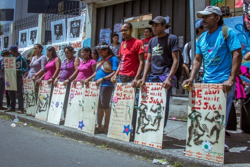 Protestors gather outside CONAIE with placards that read 'Nobody takes us from here'.