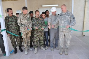 Representatives of the U.S. Army Corps of Engineers, the Afghani National Army, and DynCorp celebrate the completion of the first two phases of a $92 million construction project.
