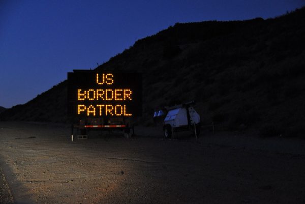 Lit-up sign by the road that reads, US Border Patrol. 