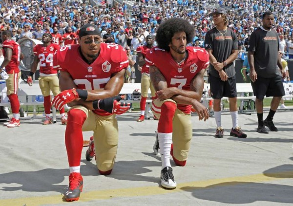 San Francisco 49ers' Colin Kaepernick and Eric Reid kneel during the national anthem. Mike McCarn, Associated Press.