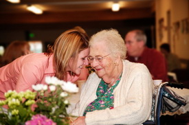 giving flowers to aging woman